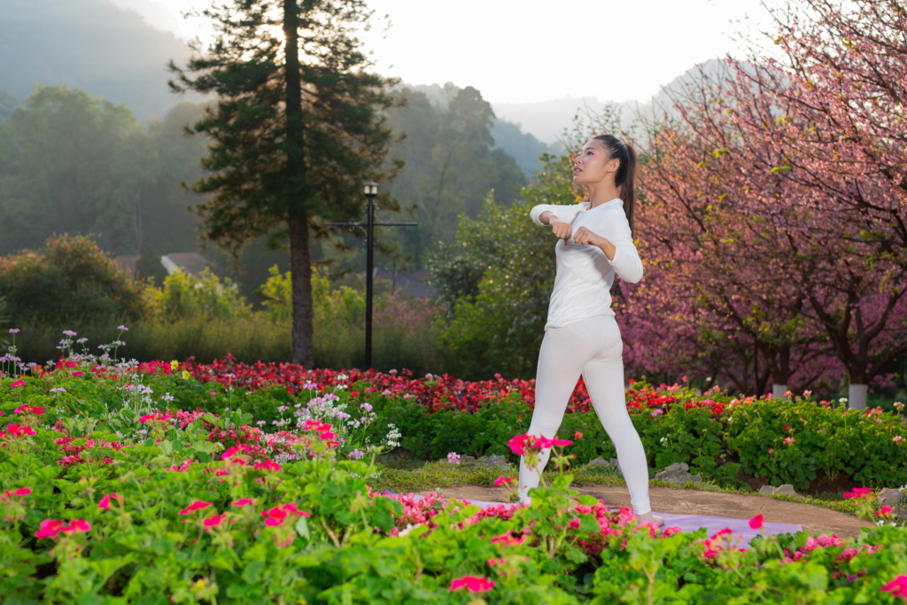 Women are playing yoga at the park. Exercising.