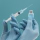vaccine-bottle-syringe-held-by-doctor-with-gloves