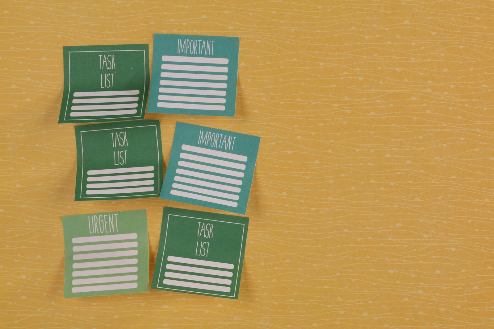 Close-up of colorful sticky notes on yellow background with task-related labels.