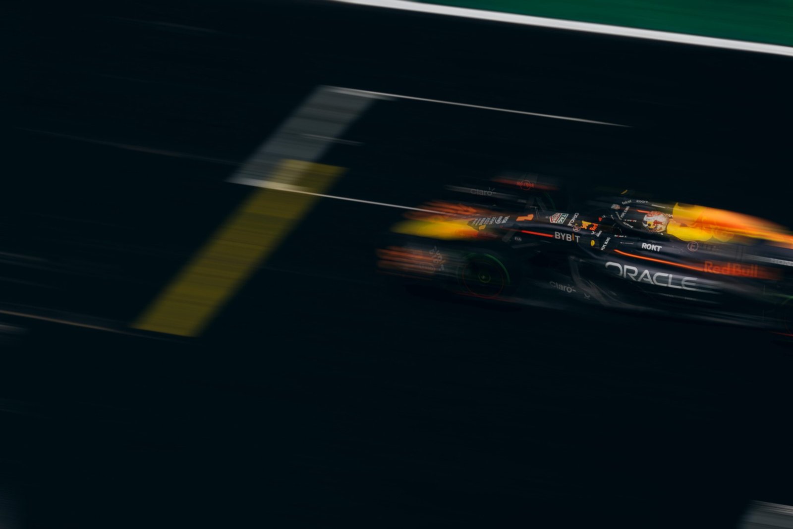 Blurred image of a Formula One car racing down the track, showcasing speed and motion.