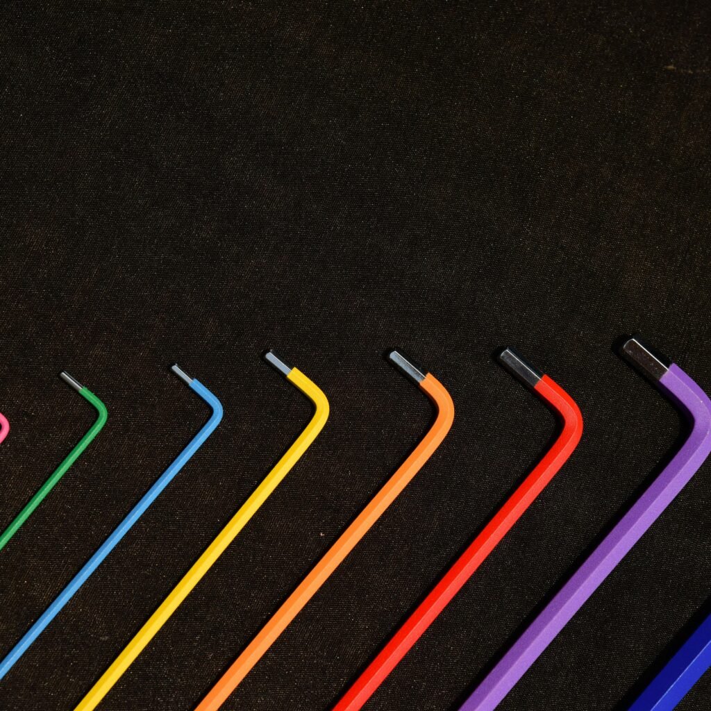 Vibrant set of hex keys in rainbow colors organized in a neat pattern on a dark backdrop.