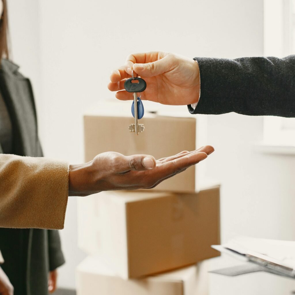 A new homeowner receives keys inside their new home, symbolizing a fresh start.