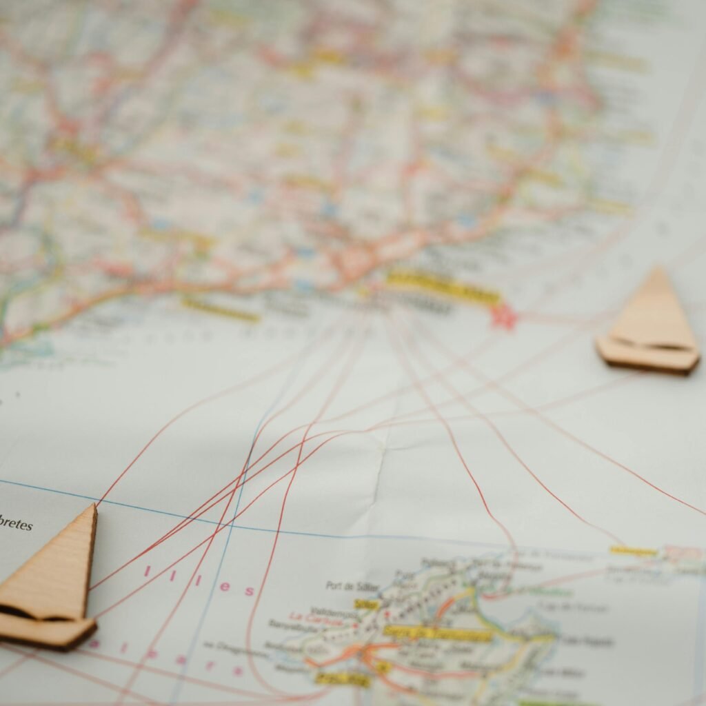 Nautical map with wooden boat markers, showing travel routes and geography. Ideal for travel planning.