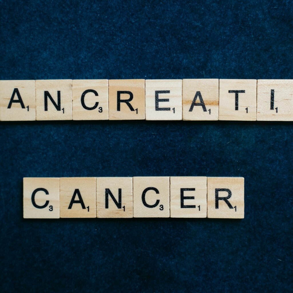 Wooden tiles spelling 'Pancreatic Cancer' on a textured blue background.