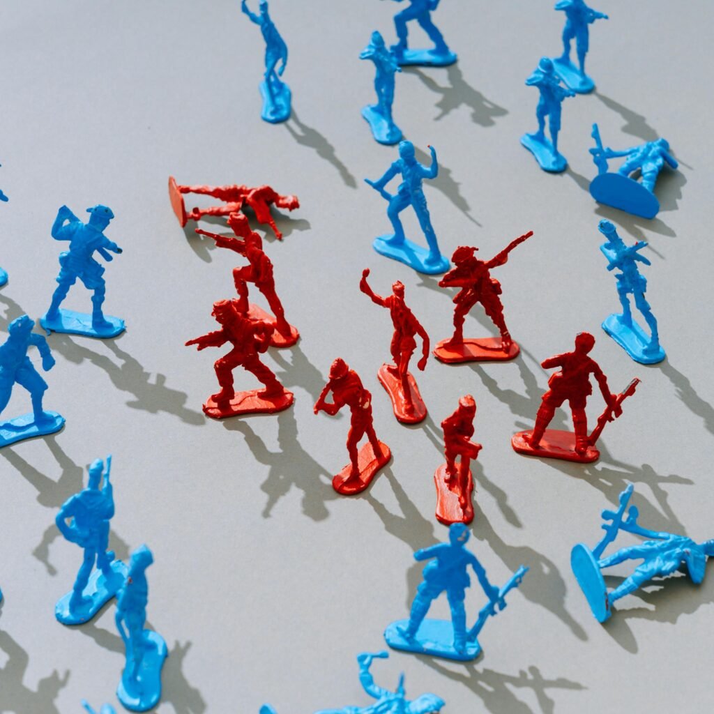 Red and blue toy soldiers on a light surface forming a strategic battle scene.