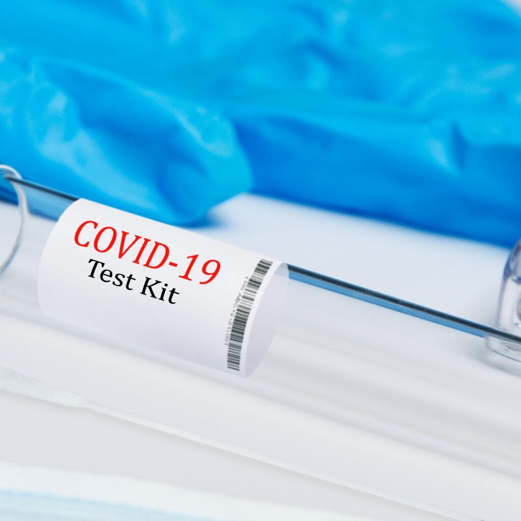 High-quality image of a COVID-19 test kit showing swab and test tube.