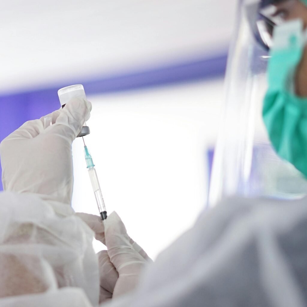 A healthcare worker preparing a syringe with vaccine, showcasing medical precision.