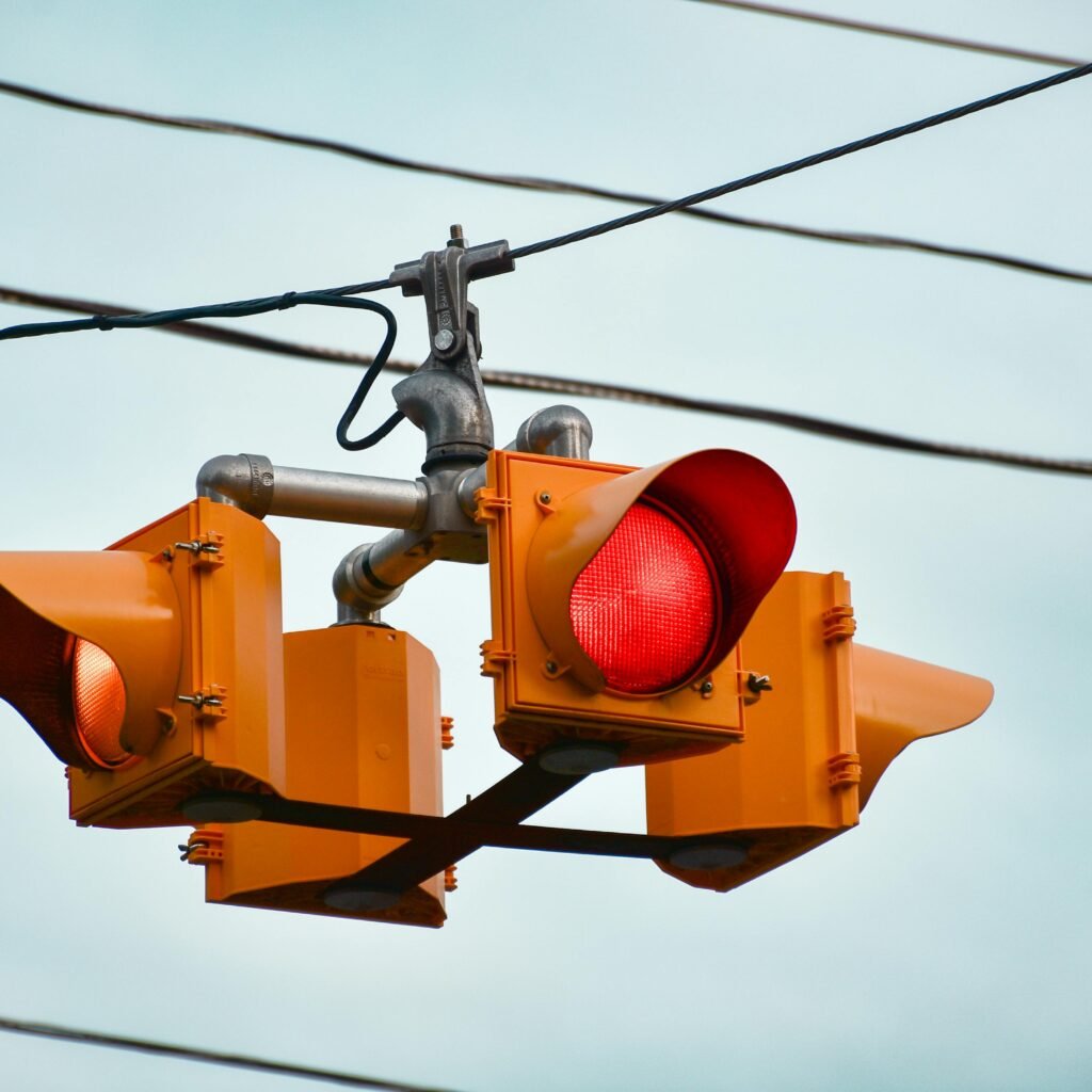 Detailed image of a red traffic light against a clear sky in Guelph, Ontario.