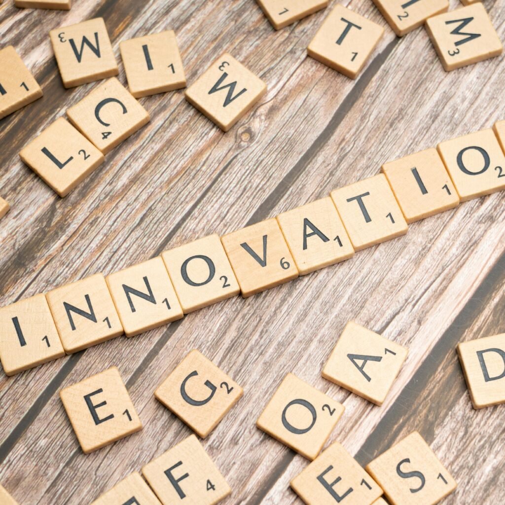 Creative display of 'Innovation' spelled with wooden letter tiles on a wooden surface.