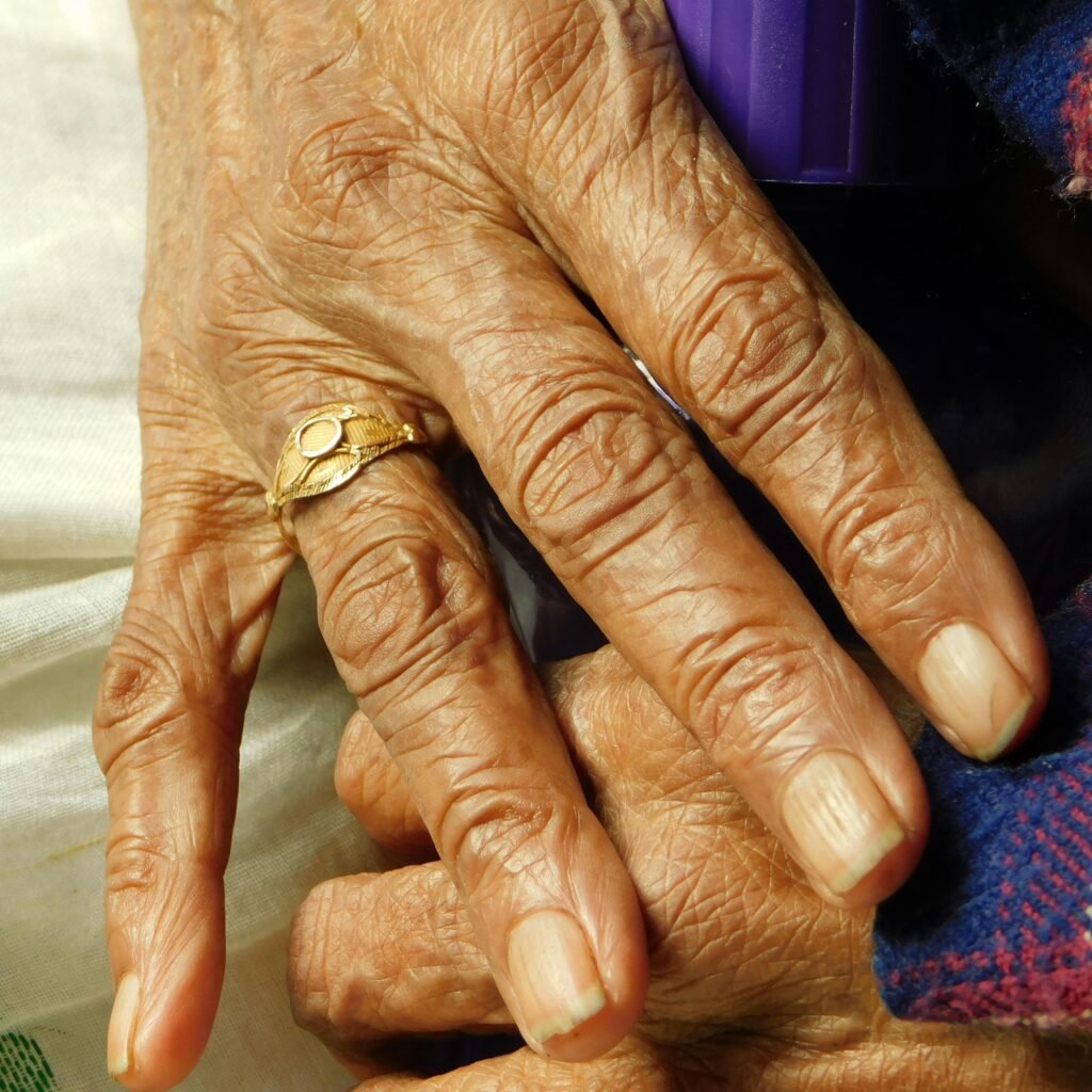 Detailed view of elderly hands with a gold ring, symbolizing wisdom and experience.