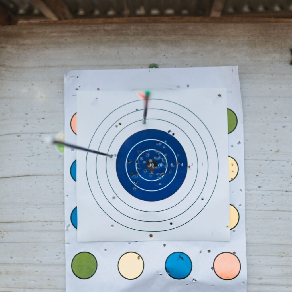 Close-up of arrows hitting a target on an archery range.