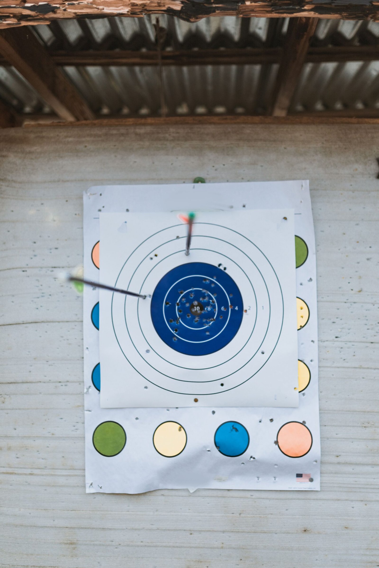 Close-up of arrows hitting a target on an archery range.