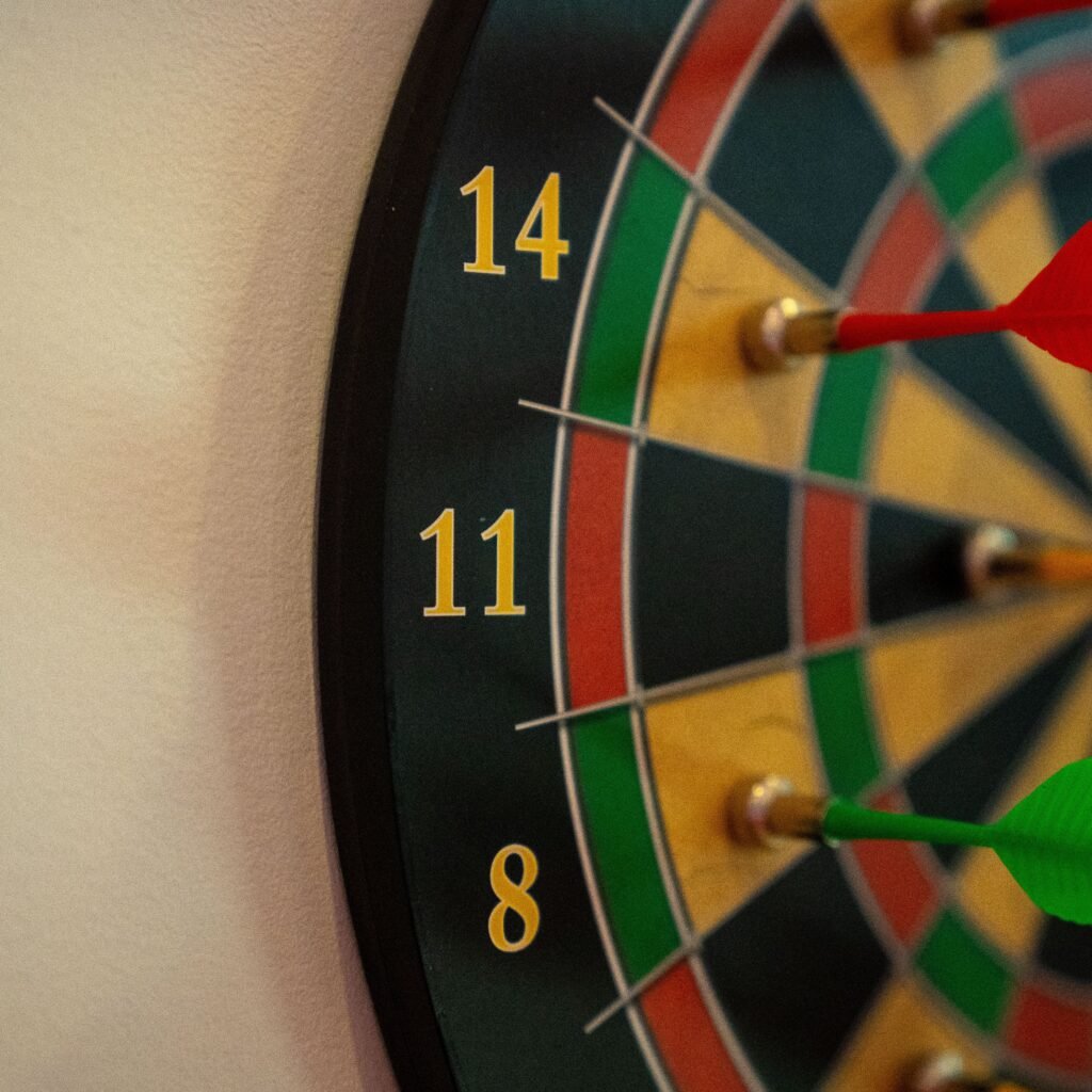 Vivid close-up of a dartboard with multicolored darts accurately striking the target.