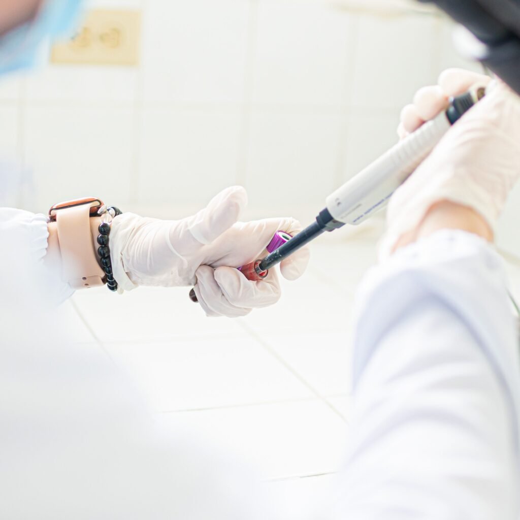 A medical professional using pipette in a lab setting, emphasizing precision and care.