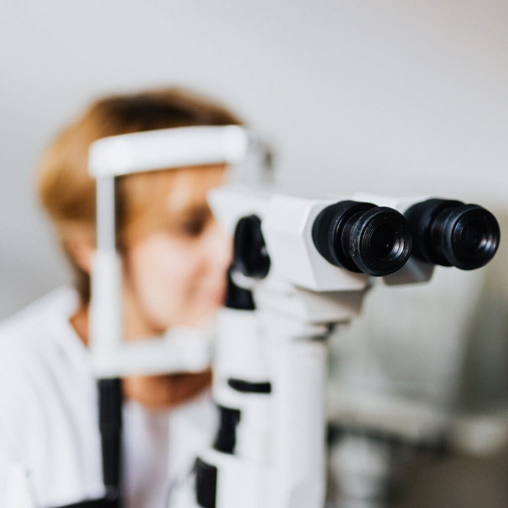 Close-up of an eye examination using a slit lamp machine in a clinical setting.