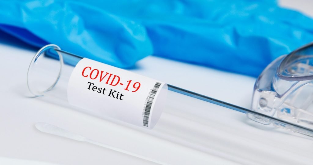 High-quality image of a COVID-19 test kit showing swab and test tube.
