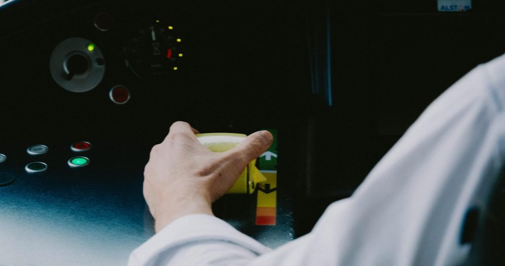 Close-up of a pilot's hand on the control dashboard in a cockpit, showcasing aviation technology.
