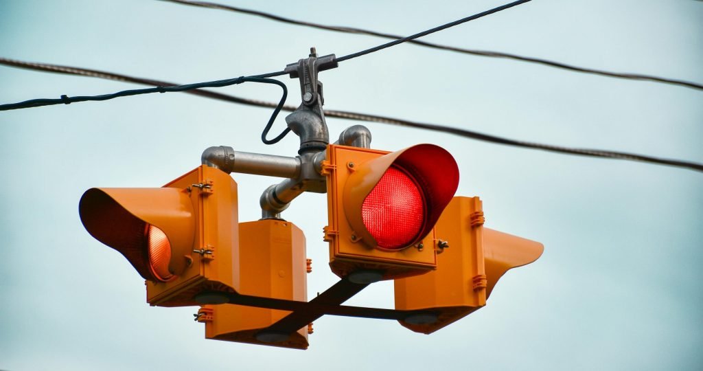 Detailed image of a red traffic light against a clear sky in Guelph, Ontario.