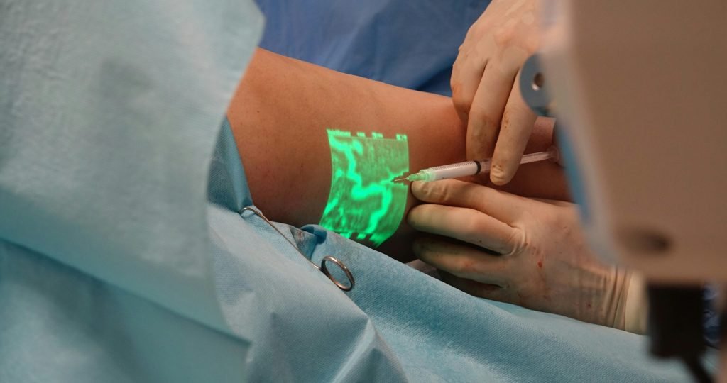 A doctor performs a medical procedure using advanced vein visualization technology.