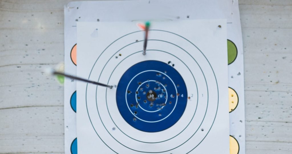 Close-up of arrows hitting a target on an archery range.