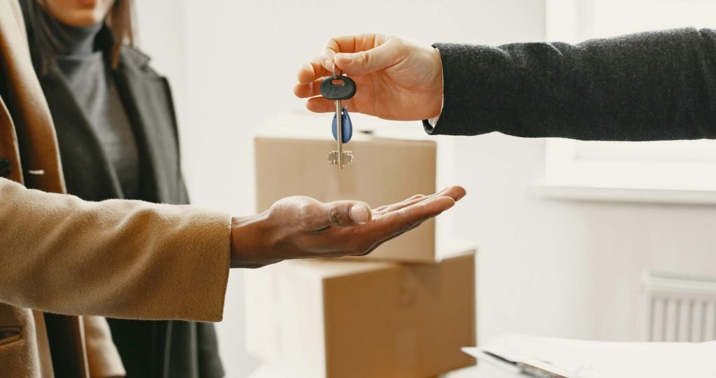 A new homeowner receives keys inside their new home, symbolizing a fresh start.