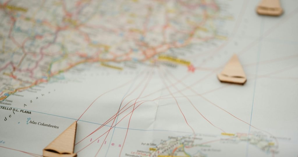 Nautical map with wooden boat markers, showing travel routes and geography. Ideal for travel planning.