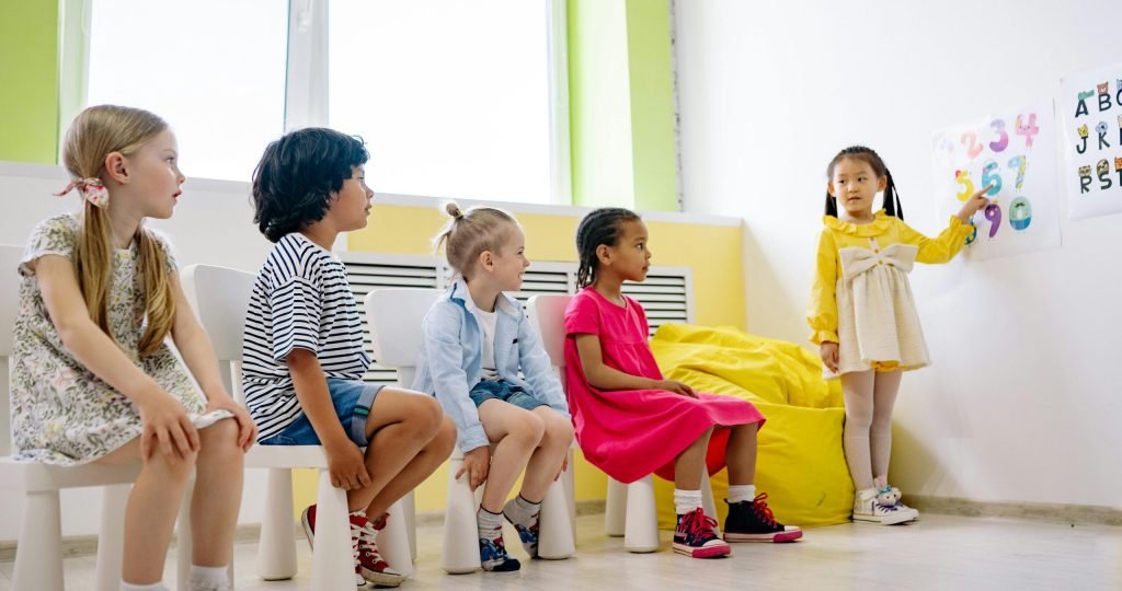 Children engaging in an interactive classroom lesson with colorful visuals, promoting diversity and education.