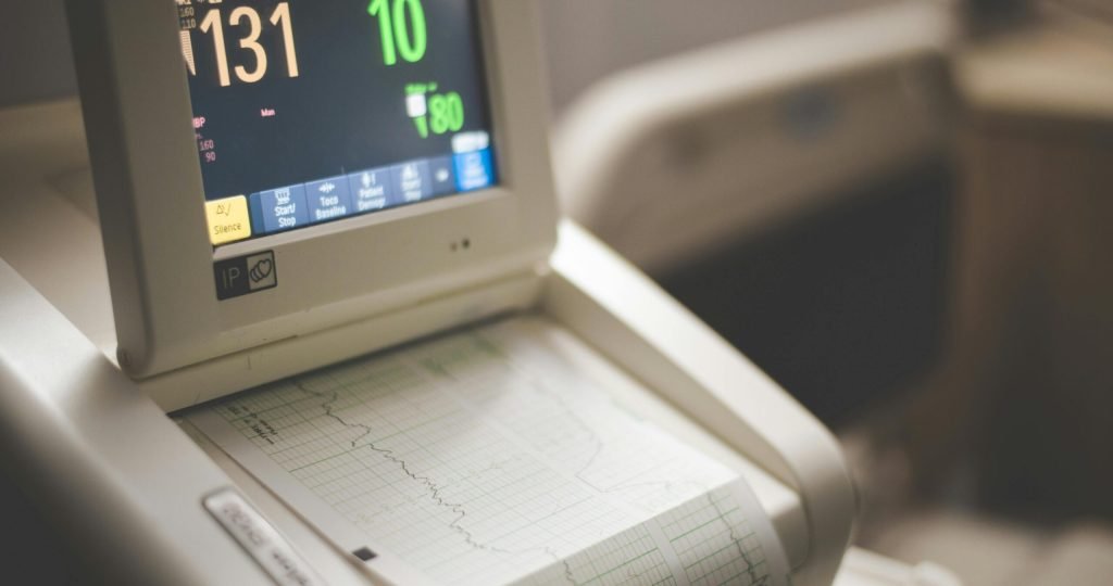 Close-up shot of a medical ECG monitor displaying heart rate and oxygen levels, essential for patient monitoring.